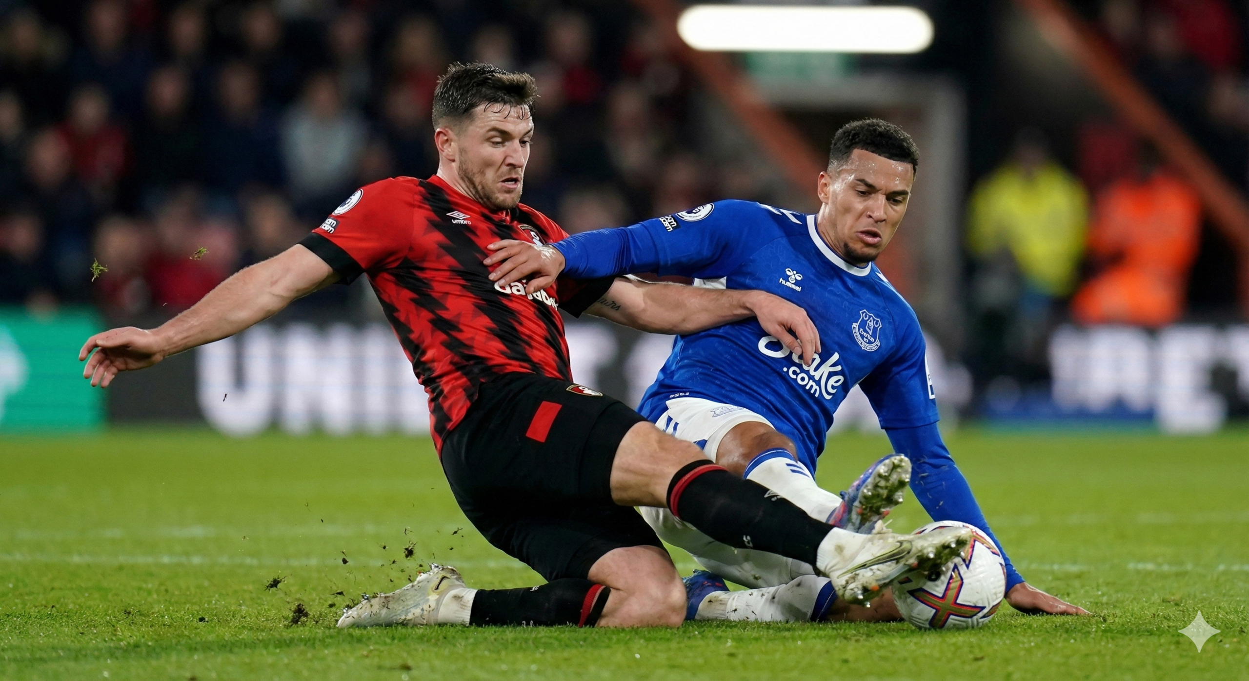 Foto jarak dekat yang menangkap momen intensitas tinggi di lapangan hijau, memperlihatkan duel fisik antara penyerang Bournemouth dan pemain bertahan Everton. Fokus gambar tertuju pada perebutan bola di atas rumput yang terawat rapi, dengan detail ekspresi wajah para pemain yang menunjukkan konsentrasi penuh dan determinasi untuk memenangkan pertandingan. Pencahayaan stadion menyoroti tekstur seragam dan gerakan dinamis pemain, melambangkan perjuangan keras kedua tim untuk mengamankan poin penting setelah kekalahan mengecewakan mereka sebelumnya, sesuai dengan prediksi pertandingan yang ketat.